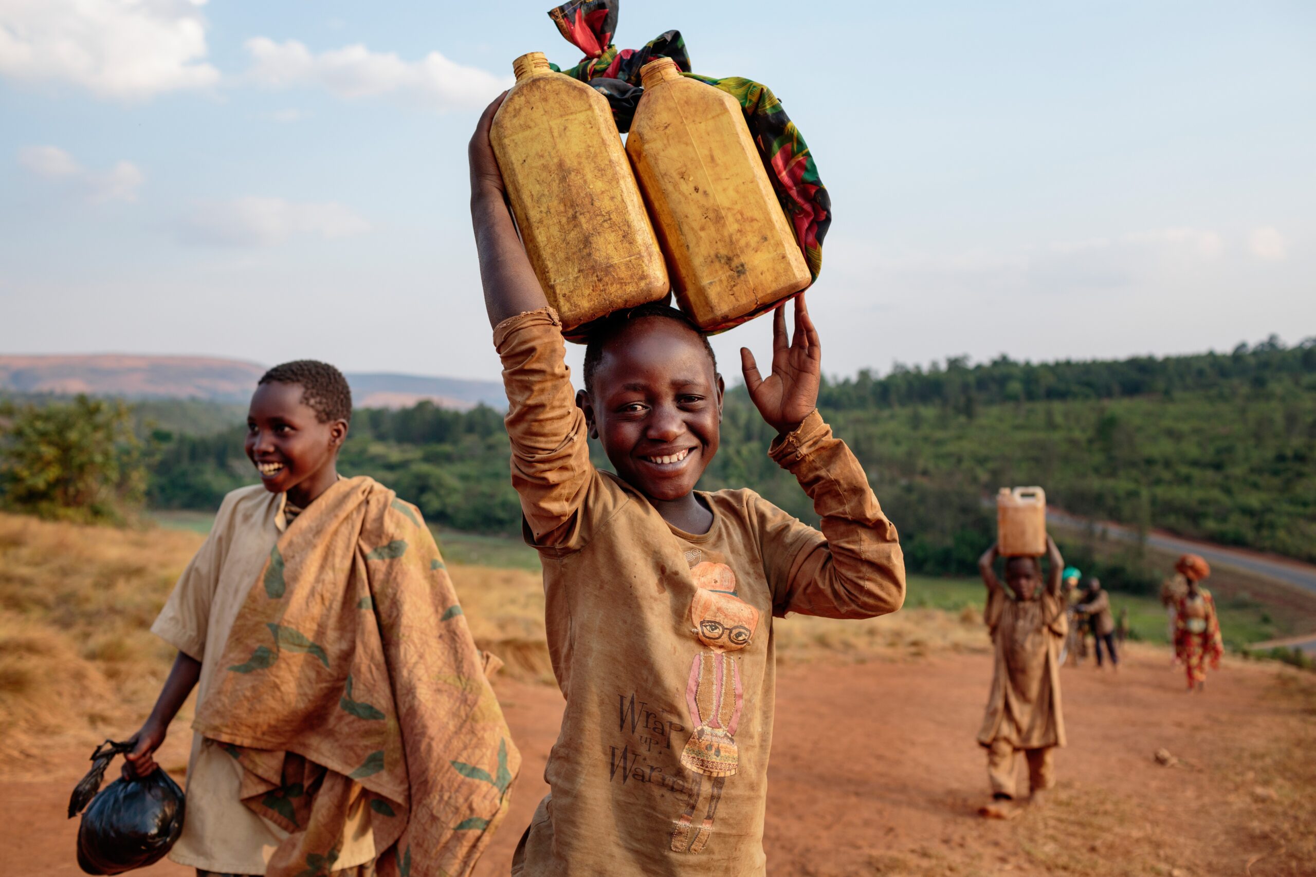 Child holding water canisters