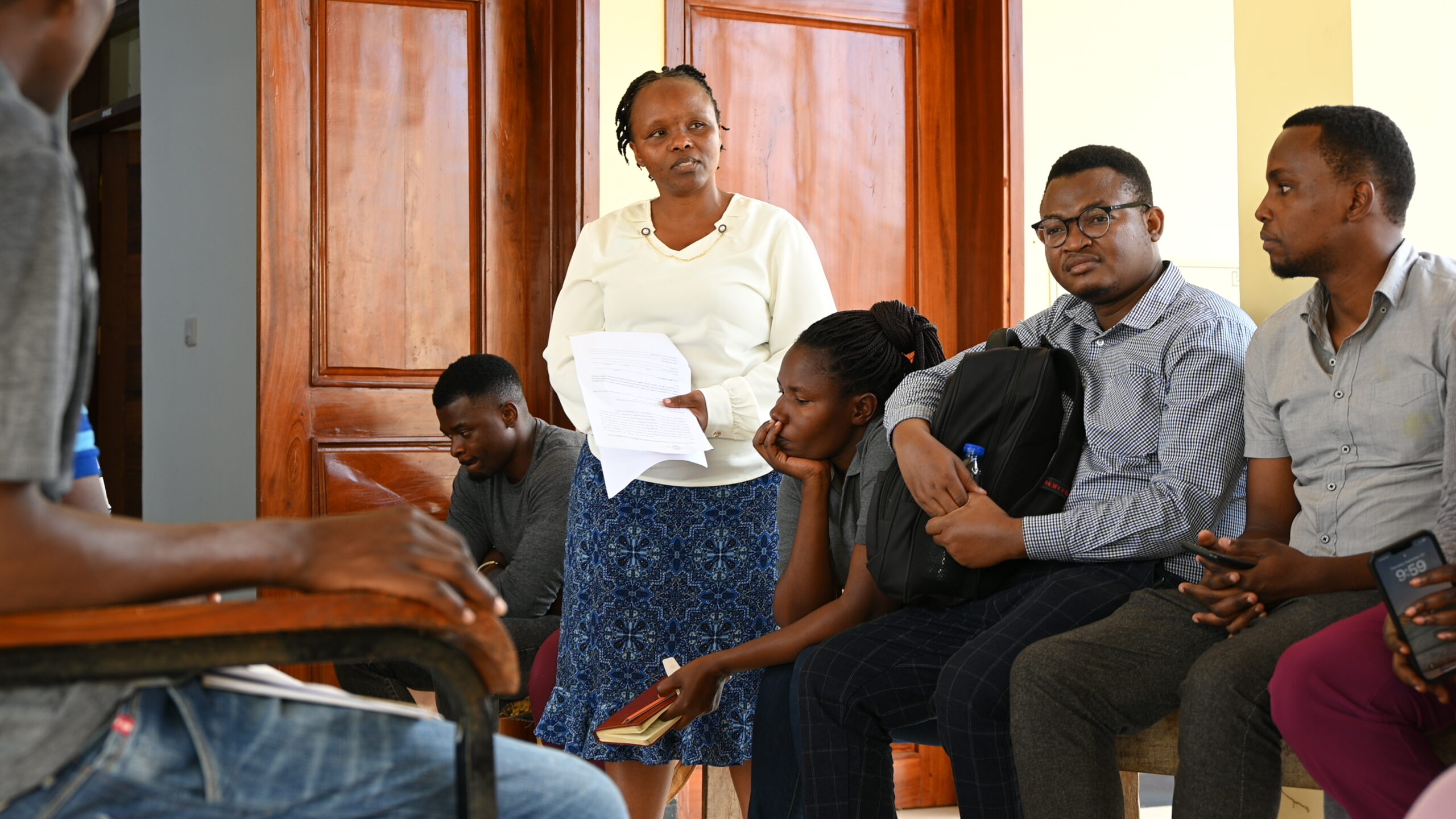 Dr. Faraja speaks to a a group at the end of a two week long program to provide surgeries to men with hydroceles.