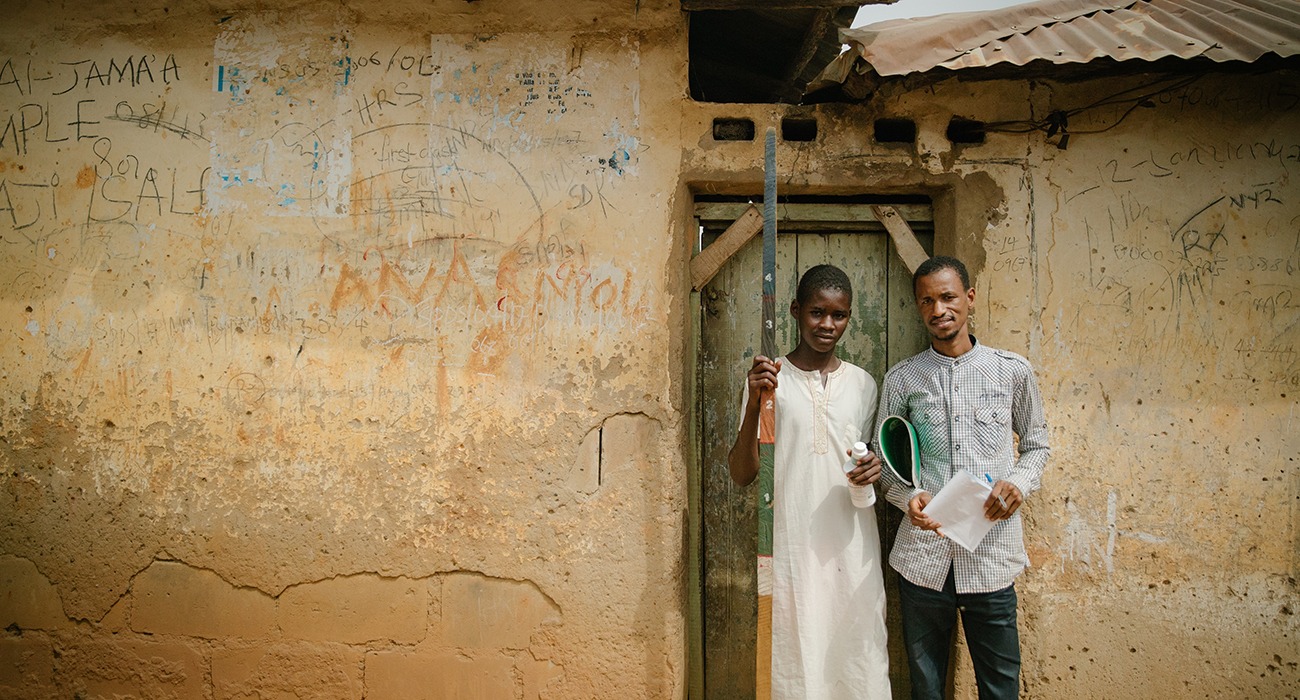 Health Workers posing in front of door.