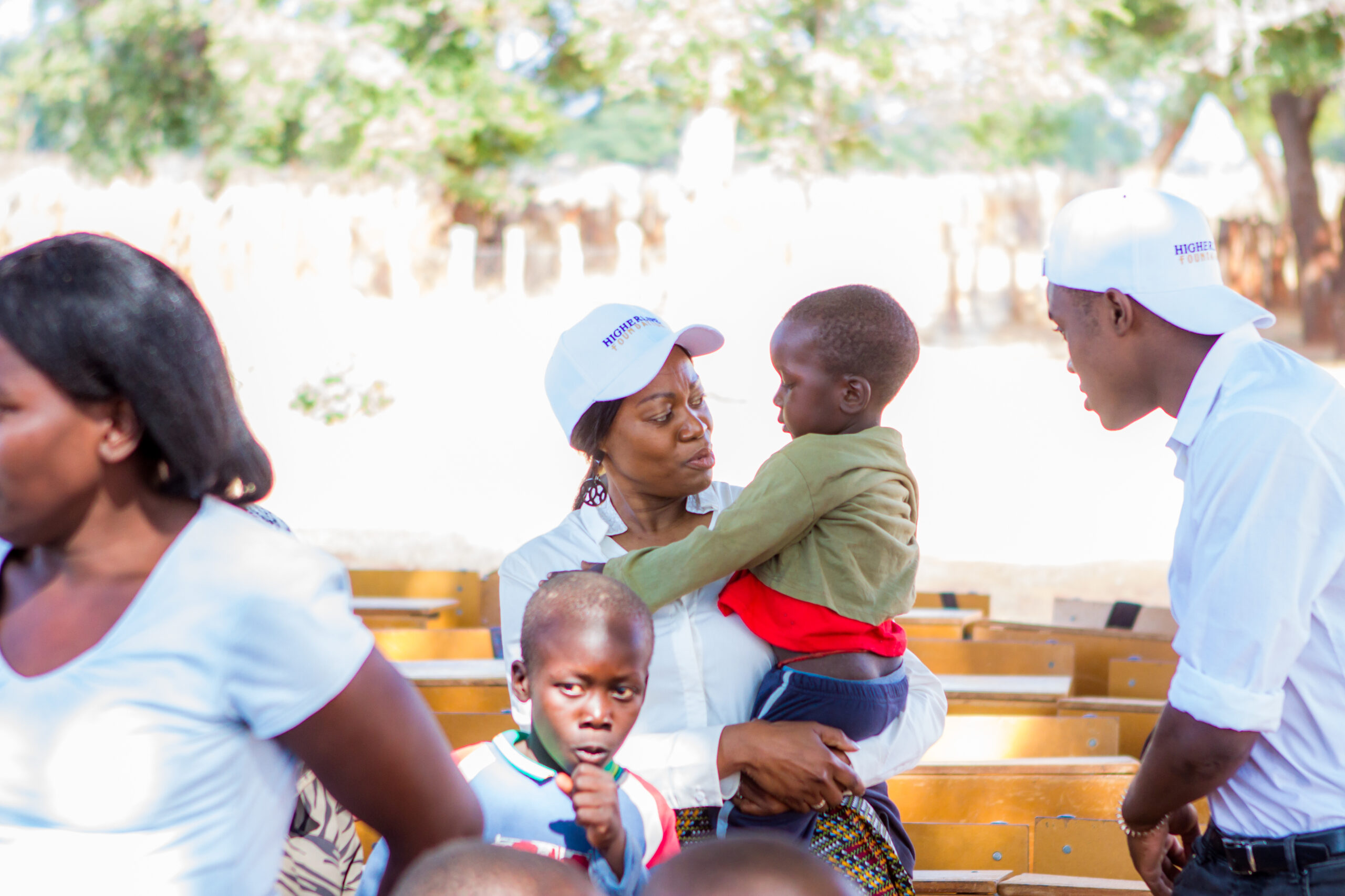 Tsitsi Masiyiwa, END Fund board chair, plays with children as she observes a mass drug administration in Zimbabwe