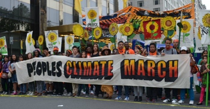 People holding climate sign