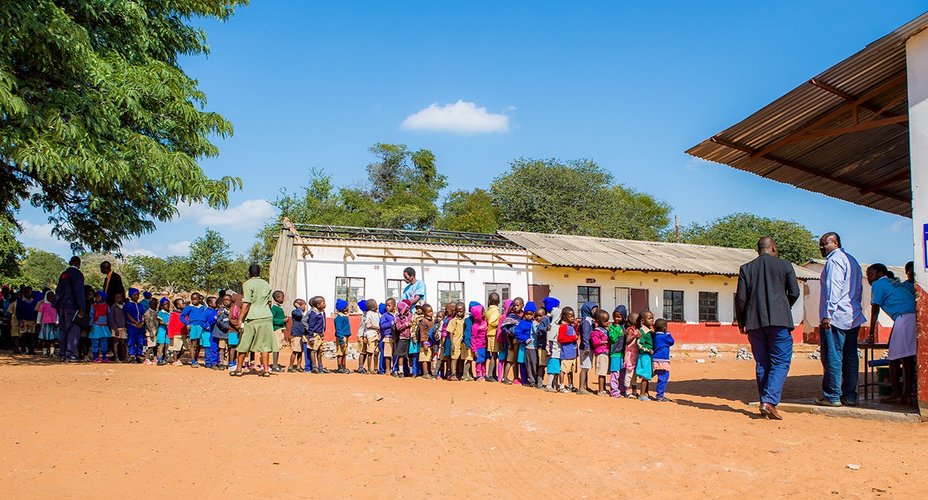 Kids waiting in line to receive medicine.