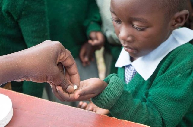 Child receiving medicine.