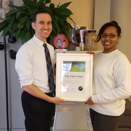 James and Yayne holding an award for the Listening Tour.