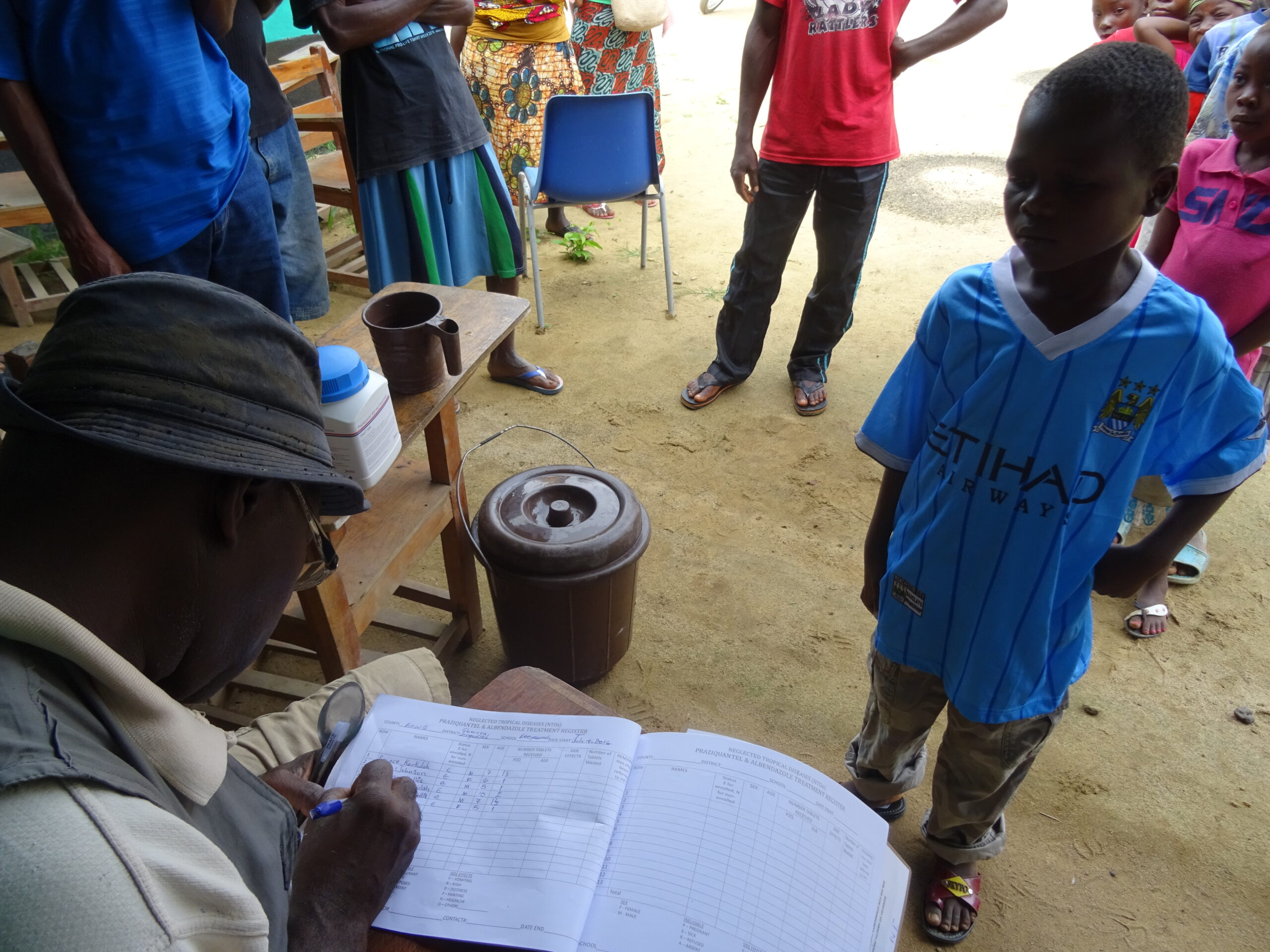 A child is recorded in a register for participating in a mass drug administration in Liberia 