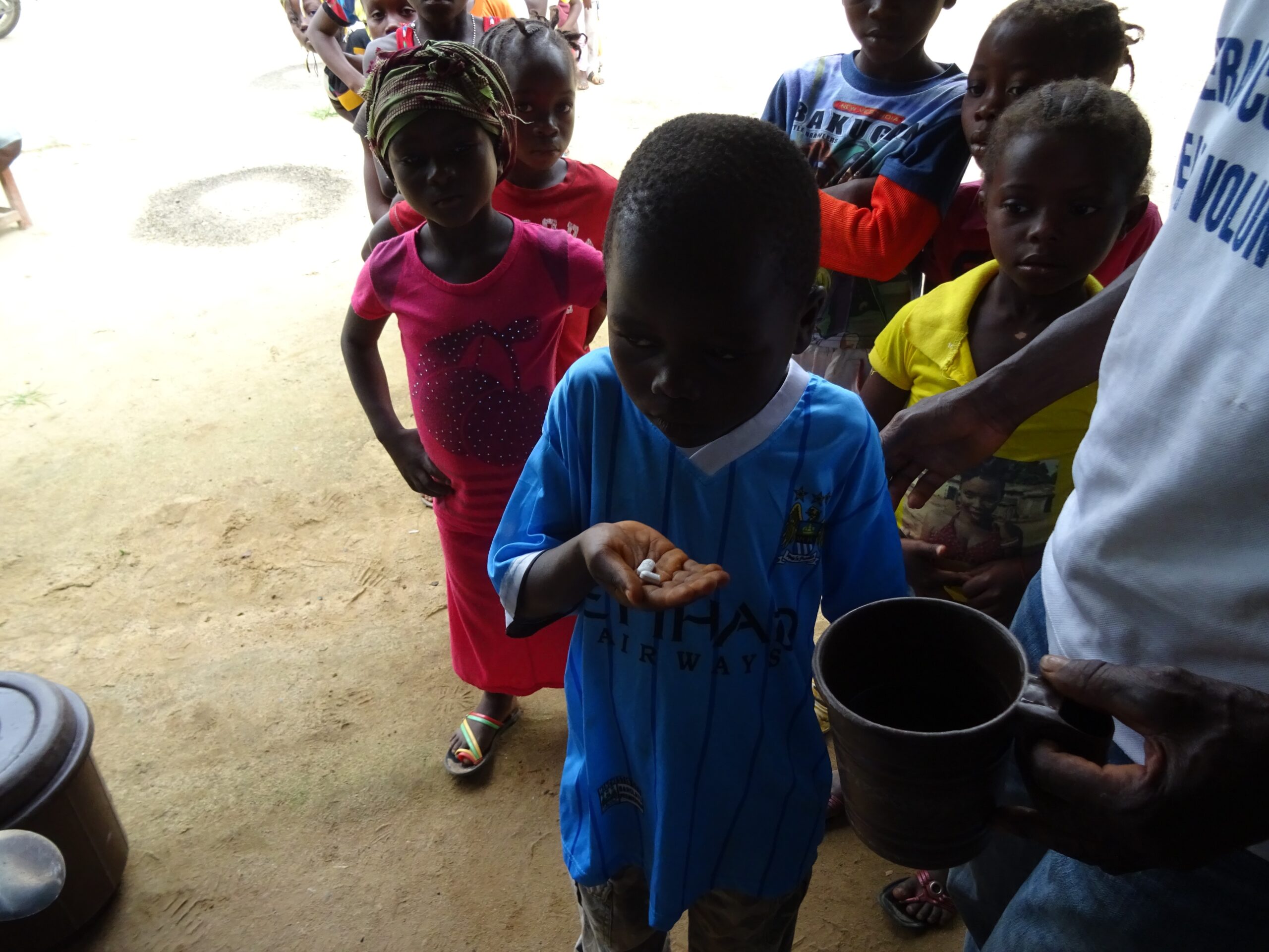 Child taking medicine in Liberia.