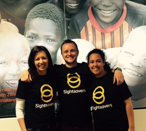 Three people posing in sightsavers t-shirts.