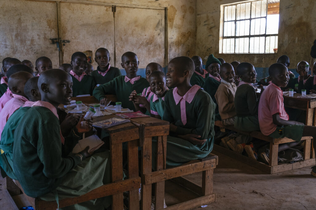 Happy Kenyan students benefit from school-based deworming programs in Kenya